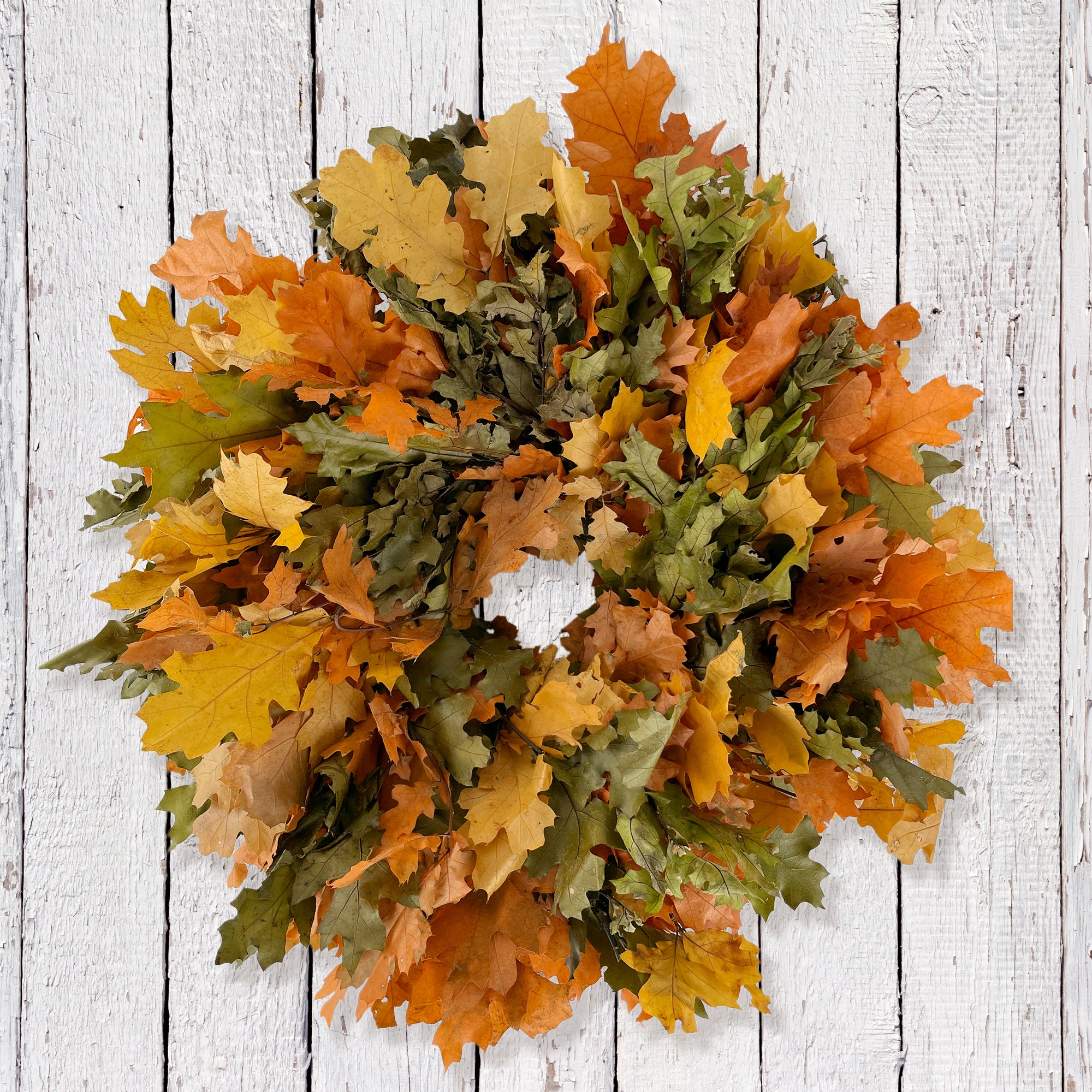 multi color oak leaf wreath against whitewashed wall
