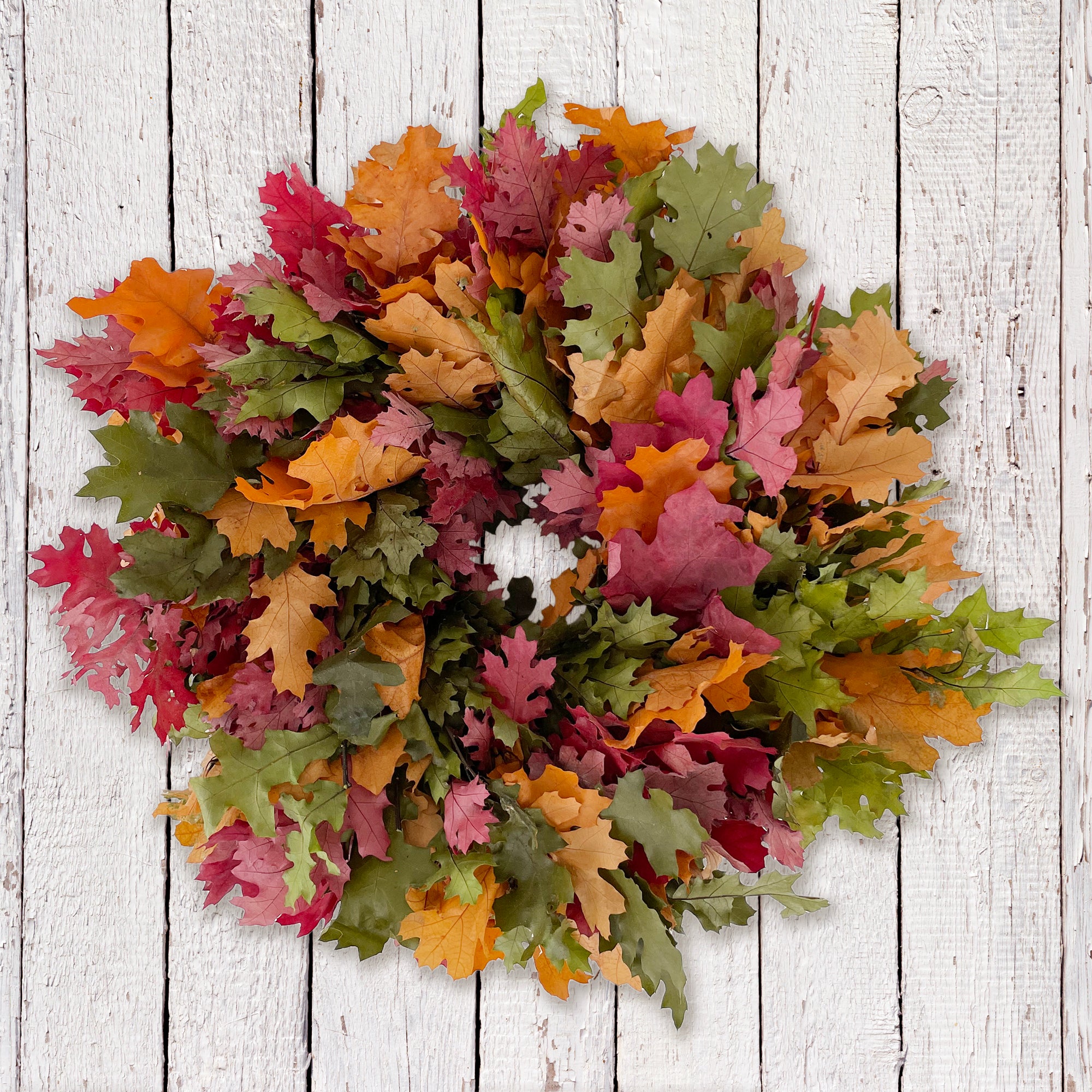 multi color oak leaf wreath against whitewashed wall
