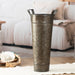Decorative metal vase on a coffee table with a blurred sofa in the background