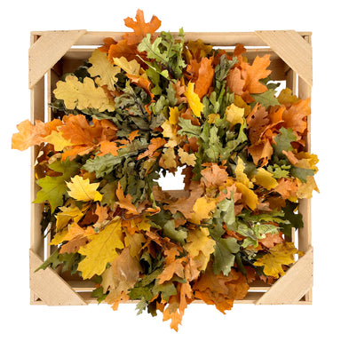multi color oak leaf wreath in wooden crate against white background