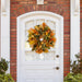 multi color oak leaf wreath against whitewashed door