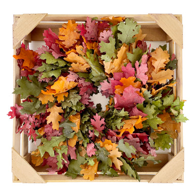 multi color oak leaf wreath in wooden crate against white background