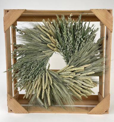 clustered mixed wheat wreath in wooden crate against white background