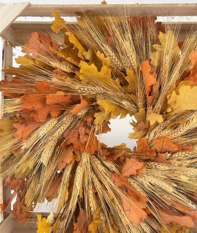 yellow and orange oak leaf mixed with blonde wheat wreath against white background